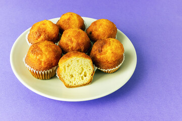 mini muffins in a plate on a purple background