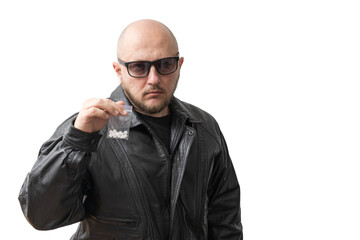 Dangerous bald man in black leather jacket and sunglasses holding plastic transparent bag with...
