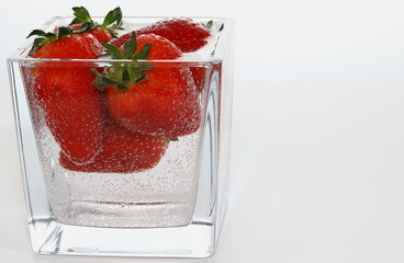 strawberries in a  glass, strawberries in water, air bubbles, delicious dessert, breakfast, vegan, vitamins, strawberry juice