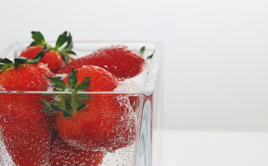 strawberries in a  glass, strawberries in water, air bubbles, delicious dessert, breakfast, vegan, vitamins, strawberry juice