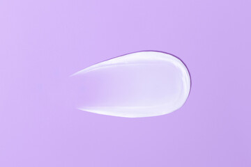 Close-up smear of cream texture on a purple background