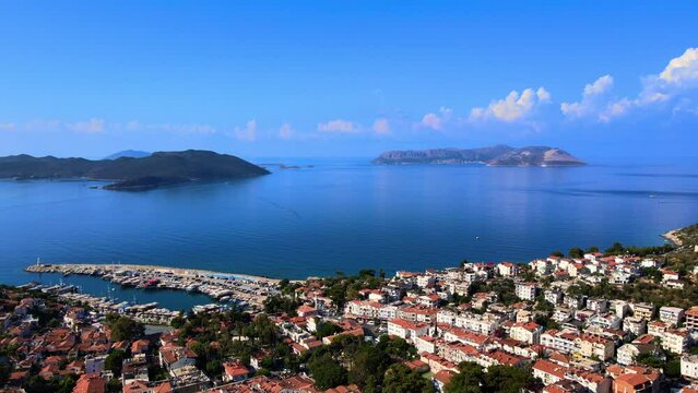 Aerial footage of Kaş center, marina, and Meis Island, highlighting the vibrant coastal landscape, turquoise waters, and Mediterranean architecture in Antalya, Turkey.