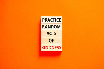 Practice random kind of kindness symbol. Concept words Practice random kind of kindness on wooden block. Beautiful orange table orange background. Business practice kindness concept. Copy space.