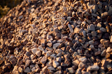 A heap of fine granite stones in the warm sunlight