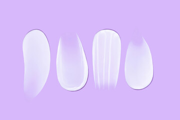 Set of smears of cream texture on blue background