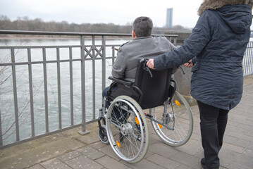 Obraz premium a physically disabled person on a wheelchair at a walk.