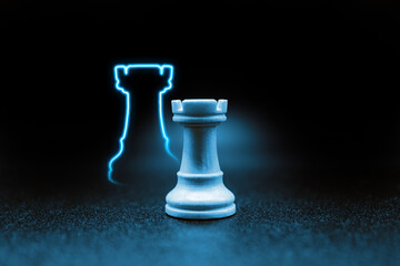 blue rook chess piece with led in the shape of the rook piece. close up photo with black...