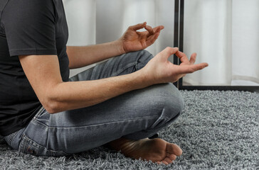 A man meditates in the lotus position.