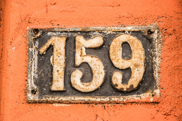 Old retro weathered cast iron plate with number 159