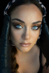 Closeup portrait of a beautiful woman with smoky eye makeup.Glamorous portrait of a beautiful woman model with fresh daily makeup and romantic wavy hairstyle. Blue-eyed hot girl