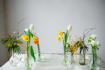Wooden table with fresh flowers in vases. Old style