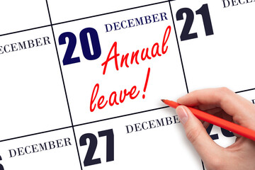 Hand writing the text ANNUAL LEAVE and drawing the sun on the calendar date December 20