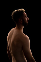 Portrait of a young man with a beard isolated on a black background