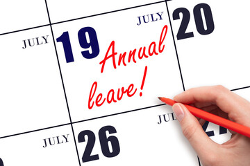 Hand writing the text ANNUAL LEAVE and drawing the sun on the calendar date July 19
