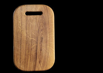 wooden cutting board on black background space for text