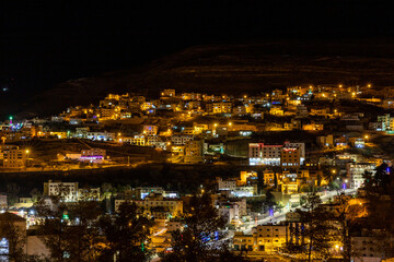 Fototapeta na wymiar Wadi Musa, Jordan A night view of the city of Petra in the hills.