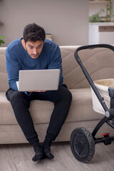 Young male contractor looking after baby at home
