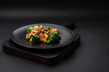 Delicious steamed vegetables broccoli, mushrooms, peas, carrots and onions