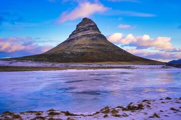 Sunrise over the Kirkjufell in winter in Iceland, the iconic mountain known from series