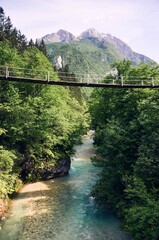 Bridge over beautiful blue apline river Koritnica, popular outdoor destination, Bovec, Slovenia, Europe.