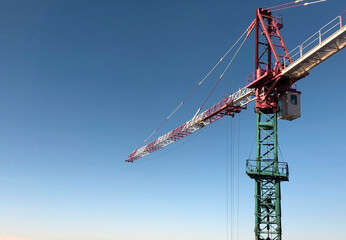 Tower crane at the construction site working on the erection of a residential building