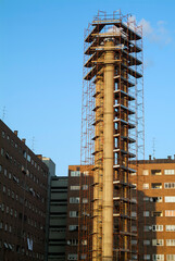 Chimney surrounded by construction scaffolding