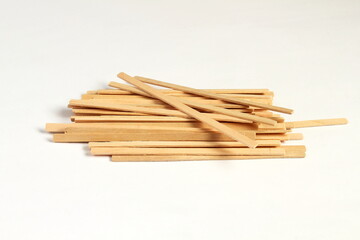 wooden stick stirrers for cofee,tea,drinks isolated on white background,copy space selective focus