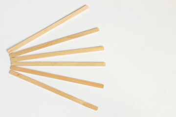 wooden stick stirrers for cofee,tea,drinks isolated on white background,copy space selective focus