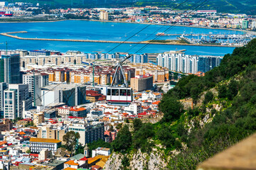 Cable car going up the Gibraltar Rock with Gibraltar town in the background, UK