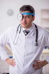 Young male doctor otolaryngologist working in the clinic