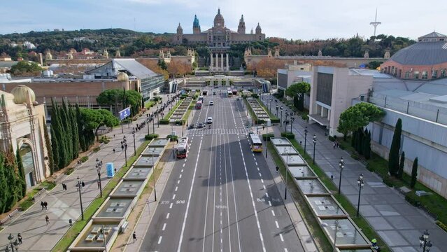 Aerial long view of Avinguda de la Reina Maria Cristina at its junction with Montjuic Palace in background. This iconic square is located at foot of Montjuic major landmark in Barcelona. 4K video