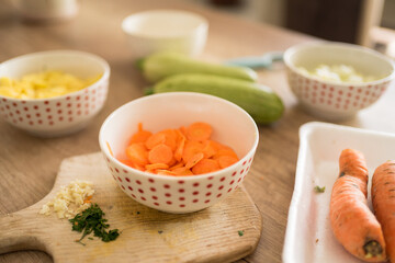 Close-up photo of chopped vegetables on the wooden table. Preparing a vegan meal.