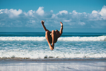 person jumping on the beach capoeira gymnast ocean free