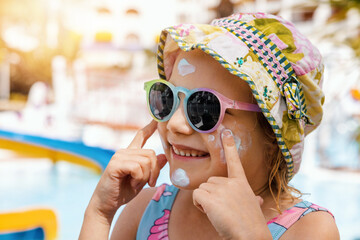 child put on sunscreen on face. skin protection from sunburn - 586742612