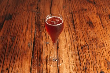 glass of red wine on wooden background