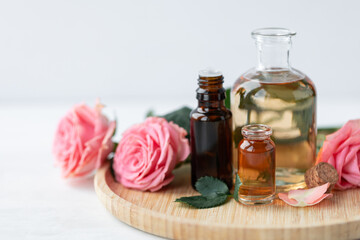 Aromatherapy. Concept of pure organic essential rose oil. Elixir with plant based floral or herbal...