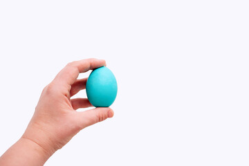 Human hand holds blue Easter egg on an isolated white background. Place for text. Mock up,