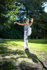 Tai Chi master woman practicing the activity for holding balance.