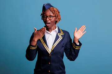 Female flight attendant excited to hear good news and feel surprised in front of the camera. Close...