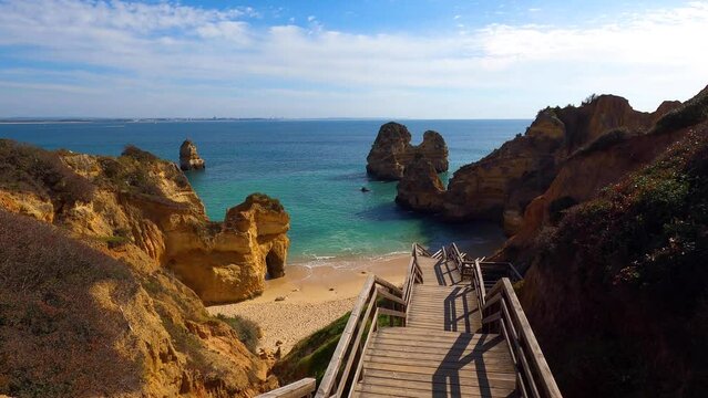 View of idyllic nature landscape with rocky cliff shore and waves crashing on. Camillo beach in Lagos. West Atlantic coast of Algarve region, south of Portugal.
