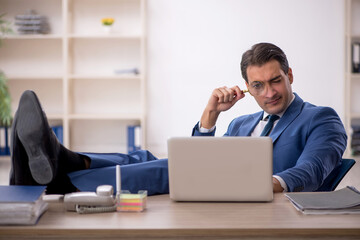 Young male employee working in the office