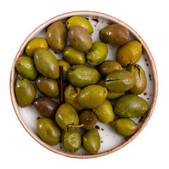 Fresh green olives with pits served on plate. Isolated over white background