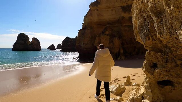 View of idyllic nature landscape with rocky cliff shore and waves crashing on. Camillo beach in Lagos. West Atlantic coast of Algarve region, south of Portugal.