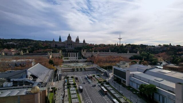 Aerial long view of Avinguda de la Reina Maria Cristina at its junction with Montjuic Palace in background. This iconic square is located at foot of Montjuic major landmark in Barcelona. 4K video