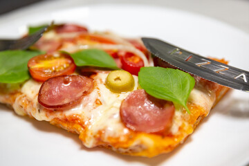 traditional pizza slice on plate in selective focus