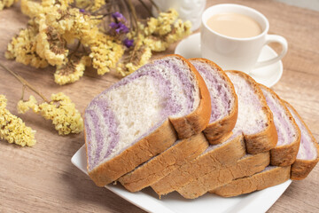 Sliced bread with taro and coffee on wooden background