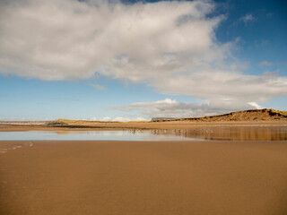 Beautiful sandy beach and blue cloudy sky. Strandhill town, county Sligo, Ireland. Popular tourist area with stunning nature scenery and view. Irish landscape. Warm sunny day.