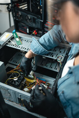 Close up of woman fixing hardware of desktop computer. Vertical photography