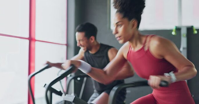 Determination, fitness and endurance with couple cycling in gym together for strength and stamina. Active, fit and bike cardio with african american friends cycle and ride for competitive exercising