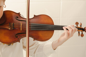 Beautiful Classical Violin Closeup with Young Woman's Hand Playing it in Musical Practice